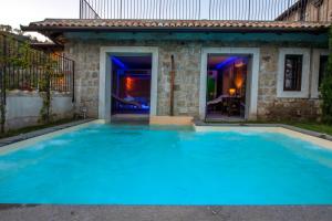 a large blue swimming pool in front of a house at Masseria del Carmine Maggiore 1817 in Pozzuoli