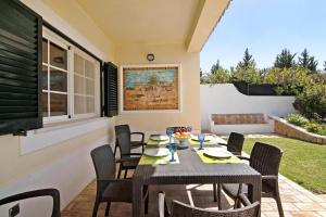 a dining room with a table and chairs on a patio at Casa dos Avós in Albufeira