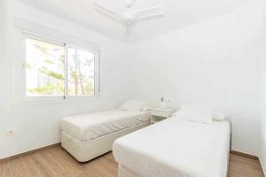 A bed or beds in a room at Santa Marta al lado de los servicios y de la playa