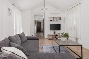 a living room with a couch and a table at Apartment DANI-E.L. in Kastav