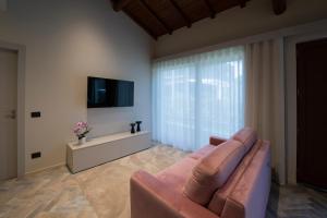 a living room with a couch and a tv at Villa Arianna in Acireale