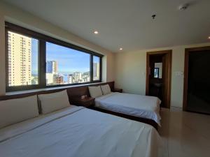 Postel nebo postele na pokoji v ubytování HỒNG HẢI 2 HOTEL + 37 fotografií