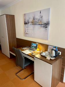 an office with a desk with a laptop computer on it at Hotel Garni Expo in Banská Bystrica