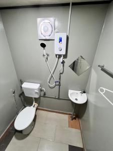 a bathroom with a toilet and a sink at Bertam Cottage Penang in Kepala Batas
