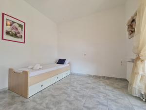 A bed or beds in a room at Myrtia Guest House