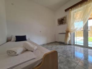 A bed or beds in a room at Myrtia Guest House