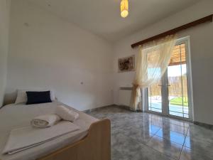 A bed or beds in a room at Myrtia Guest House