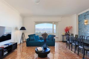 a living room with a blue couch and chairs at Lago 270 in Stresa