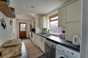 a kitchen with a sink and a dishwasher at Guest Homes - Severn Swans House in Worcester