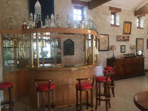 a bar with red stools in a room at Villa Charentaise avec piscine privée in Chazelles