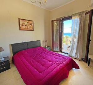 een slaapkamer met een groot roze bed en een raam bij Kimata Sea View Apartment in Argassi