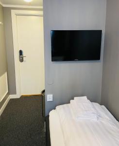 a hotel room with a television and a bed at Birka Hotel in Stockholm