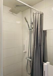 a shower with a shower curtain in a bathroom at Birka Hotel in Stockholm