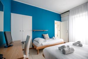 Postel nebo postele na pokoji v ubytování Hotel Hc Resort Lignano