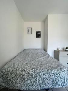 a white bedroom with a bed and a dresser at Le Studio 36 à Nîmes, Wifi, Balcon in Nîmes