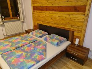 a bedroom with a bed and two pillows on it at Ferienwohnung Haus Oberlarchhof in Bayrischzell