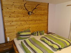 a bedroom with a bed with a wooden headboard at Ferienwohnung Haus Oberlarchhof in Bayrischzell