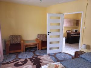 a bedroom with a door open to a living room at Domek u Jadzi in Zwierzyniec