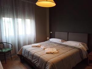 a bedroom with a bed with towels on it at Albergo Italia di Nardi Renzo & C Snc in Poggibonsi +22 photos