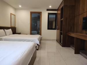 Postel nebo postele na pokoji v ubytování HỒNG HẢI 2 HOTEL