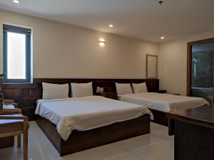 Postel nebo postele na pokoji v ubytování HỒNG HẢI 2 HOTEL