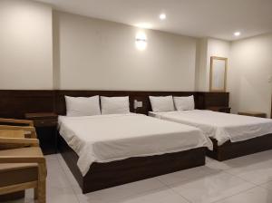 Postel nebo postele na pokoji v ubytování HỒNG HẢI 2 HOTEL