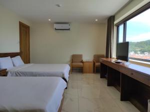 Postel nebo postele na pokoji v ubytování HỒNG HẢI 2 HOTEL