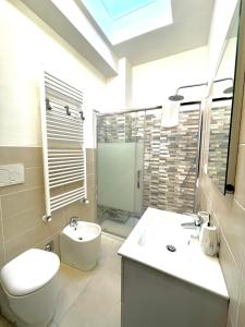 a bathroom with a sink and a toilet and a shower at Lugaro Guest House in Turin