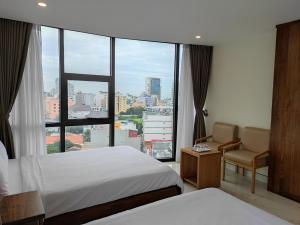 Postel nebo postele na pokoji v ubytování HỒNG HẢI 2 HOTEL