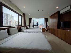 Postel nebo postele na pokoji v ubytování HỒNG HẢI 2 HOTEL