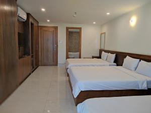 Postel nebo postele na pokoji v ubytování HỒNG HẢI 2 HOTEL
