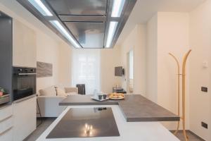 a kitchen and living room with a table in a room at Enchanted Como Lake - City Apartment by Rent All Como in Como