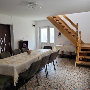 a room with a table and chairs and a staircase at Casa UILA in Orşova
