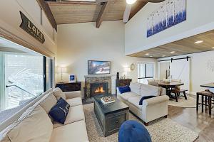 a living room with a couch and a fireplace at Forest Pines Condo 1 - 46 in Incline Village