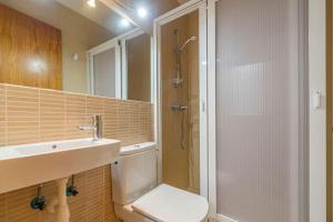 a bathroom with a shower and a toilet and a sink at Tramontana 115 P1 in Fornells