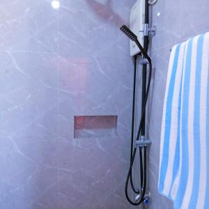 a shower in a bathroom with a shower at Baywalk Suites Batangas in Laurel