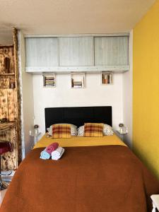 a bedroom with a bed with two slippers on it at Le Studio Victoria II -Mon Desert Village -27m2 in Nancy