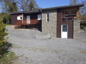 a house with a porch and a deck at Le p'tit de l'Ecureuil in Sougné-Remouchamps