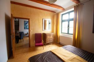 a bedroom with a bed and a desk and a window at Apartment Sirius E in center of CB in České Budějovice