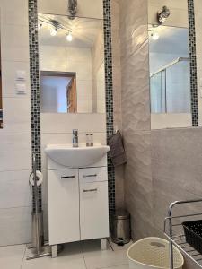 a bathroom with a white sink and a mirror at Stolove Chatki Radków in Radków +150 photos
