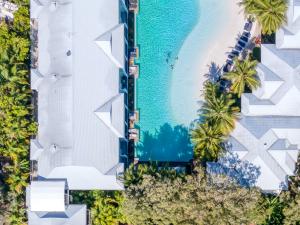 an aerial view of the beach and the pool at the resort at Beach Club Port Douglas Luxury Apartments in Port Douglas