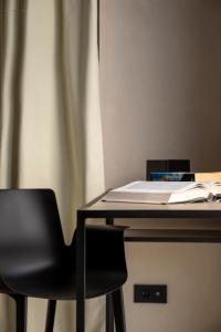a desk with a chair and a laptop on it at Moro Inn in Korčula