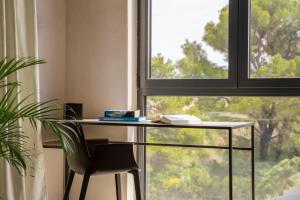 a desk with a chair in front of a window at Moro Inn in Korčula