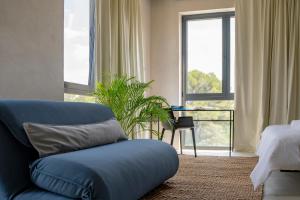 a living room with a blue couch and a bed at Moro Inn in Korčula