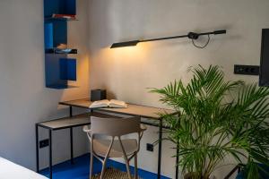 an office with a desk and a chair and plants at Moro Inn in Korčula