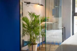 a mirror in a bedroom with two potted plants at Moro Inn in Korčula