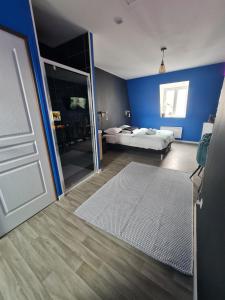 een slaapkamer met een bed en een deur met een spiegel bij NG SuiteHome - Lille I Roubaix Centre I 121 - Gamer - Arcade de jeux - Netflix - Wifi in Roubaix