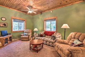 a living room with a couch and chairs and a tv at Secluded Bear Lake Getaway with Fire Pit and Porch! in Arcadia