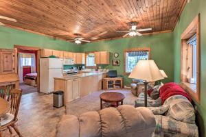 a living room with a couch and a kitchen at Secluded Bear Lake Getaway with Fire Pit and Porch! in Arcadia