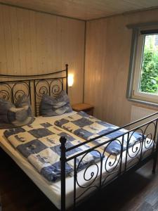 a bedroom with a bed with a quilt on it at Ferienhaus 8 am See in Granzow in Mirow